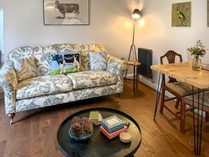 a living room with a couch and a table at The Cowshed - Uk50803 in Cratfield