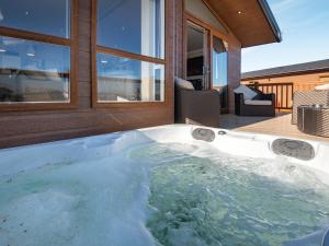 a jacuzzi tub in front of a house at Buff Lake - Uk37725 in Ingoldmells
