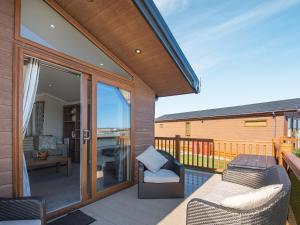 an outdoor patio with two chairs and a table at Buff Lake - Uk37725 in Ingoldmells