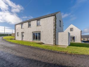 a white building on the side of a road at The Cornstore - Uk32513 in Marloes