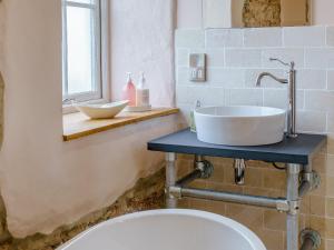 a bathroom with a sink and a toilet at The Cornstore - Uk32513 in Marloes