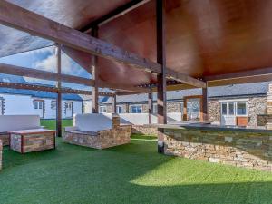 an outdoor patio with a bench and a stone wall at The Cornstore - Uk32513 in Marloes +32 photos