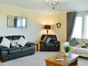 a living room with two chairs and a couch at Wheatfield House in Kilmaurs