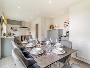 a kitchen and dining room with a table and chairs at Longridge in Peldon +27 photos