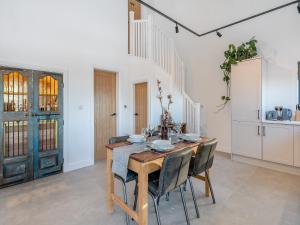a dining room with a wooden table and chairs at Moorgate Lodge - Uk47742 in Kelbrook +20 photos