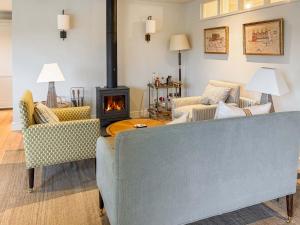 a living room with a couch and a fireplace at Cairn Ryan in Saint Mawes