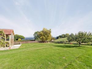 a large grassy yard with a house and trees at The Row in Much Marcle