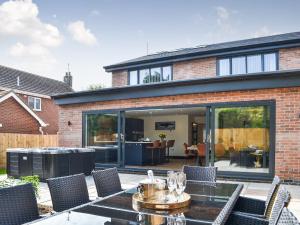 an extension of a house with a patio with a table and chairs at Linden Manor in Bridlington +18 photos