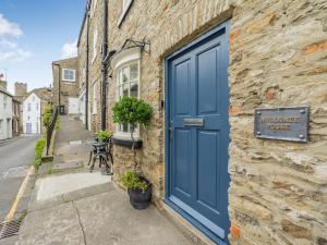 a blue door on the side of a stone building at Millgate Fosse Cottage in Richmond +27 photos