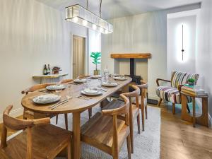 a dining room with a wooden table and chairs at Hovera Cottage in Windermere +19 photos