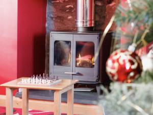 a chess board on a table in front of a fireplace at Bwthyn Onnen-Oa5 in Ystrad Meurig
