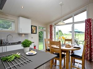 a kitchen and dining room with a table and chairs at Willow Lodge in Hassocks