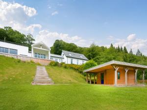 a group of houses on a hill with a green yard at Chapelburn in Lawers