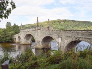 an old stone bridge over a river at Chapelburn in Lawers
