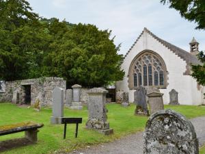 a church with a bunch of graves in front of it at Chapelburn in Lawers