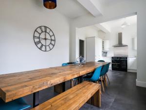 a kitchen with a large wooden table and blue chairs at Salt House - Uk43012 in Berkeley
