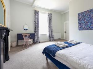 a bedroom with a bed and a chair and a window at Salt House - Uk43012 in Berkeley +17 photos