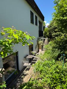 a patio with two benches and a building at Apartment Ammersee in Dießen am Ammersee