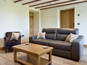 a living room with a couch and a coffee table at Deer Park - Uk33360 in Reeth