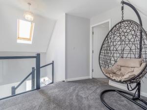 a room with a hanging chair in a room at The Old School House in Barnsley