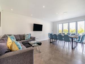 a living room with a couch and a table and chairs at The Old School House in Barnsley