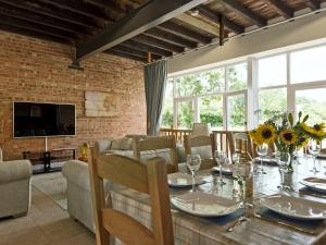 a dining room with a table and a couch at Church View - Ukc2302 in Wainfleet All Saints