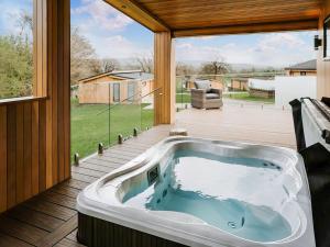 a jacuzzi tub on the deck of a house at Kiri - Uk51106 in Clitheroe