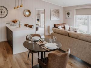 a kitchen and living room with a table and a couch at Kiri - Uk51106 in Clitheroe +8 photos