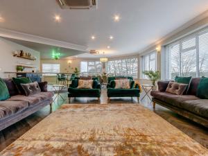 a living room with couches and a table at Fairview in Penicuik