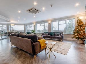a living room with a christmas tree and a couch at Fairview in Penicuik