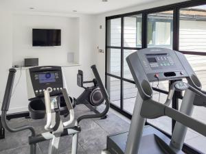 a gym with two tread machines and a treadmill at Foxton Barn - Uk47297 in Harrietsham