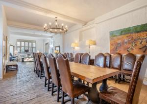 a dining room with a wooden table and chairs at Oxnead Hall in Brampton
