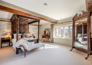 a large bedroom with a large mirror and a bed at Oxnead Hall in Brampton
