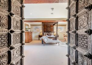 an open door into a living room with a bedroom at Oxnead Hall in Brampton +27 photos