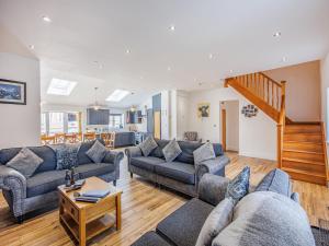 a living room with couches and a staircase at Cor Tarw - Uk12743 in Acrefair