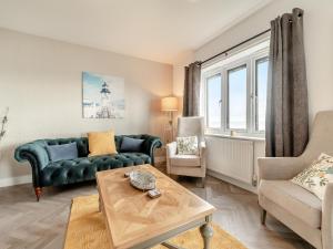 a living room with a couch and a table at Sandbanks in Bridlington