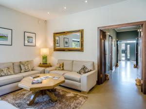 a living room with a couch and a table at Auld Kirk House in Duns
