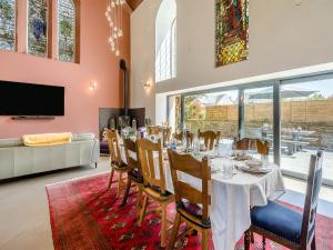 a dining room with a long table and chairs at Auld Kirk House in Duns +26 photos