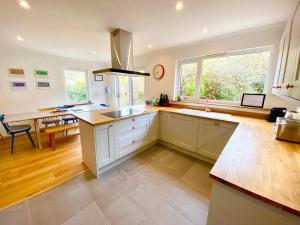 a large kitchen with a sink and a window at Seagrass in Lamlash