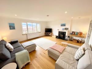 a living room with a couch and a table at Seagrass in Lamlash