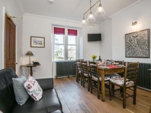 a living room with a dining room table and chairs at The Laburnums in Askham