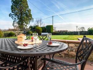 a black table with two glasses on top of it at The Laburnums in Askham +22 photos