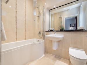 a bathroom with a sink toilet and a mirror at Apartment 14, Hazelwood Hall in Silverdale