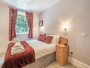 a bedroom with a bed and a window at Apartment 14, Hazelwood Hall in Silverdale