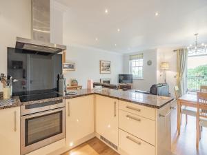 a kitchen with white cabinets and a counter top at Apartment 14, Hazelwood Hall in Silverdale