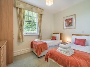 a bedroom with two beds and a window at Apartment 14, Hazelwood Hall in Silverdale +8 photos