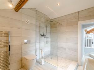 a bathroom with a shower and a toilet and a tub at Cragdale Penthouse in Settle