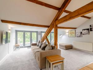 a living room with a couch and a table at Cragdale Penthouse in Settle