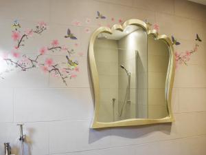 a bathroom with a mirror and butterflies on the wall at The Old Stables in Glasgow