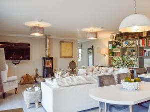 a living room with a white couch and a table at The Old Stables in Glasgow